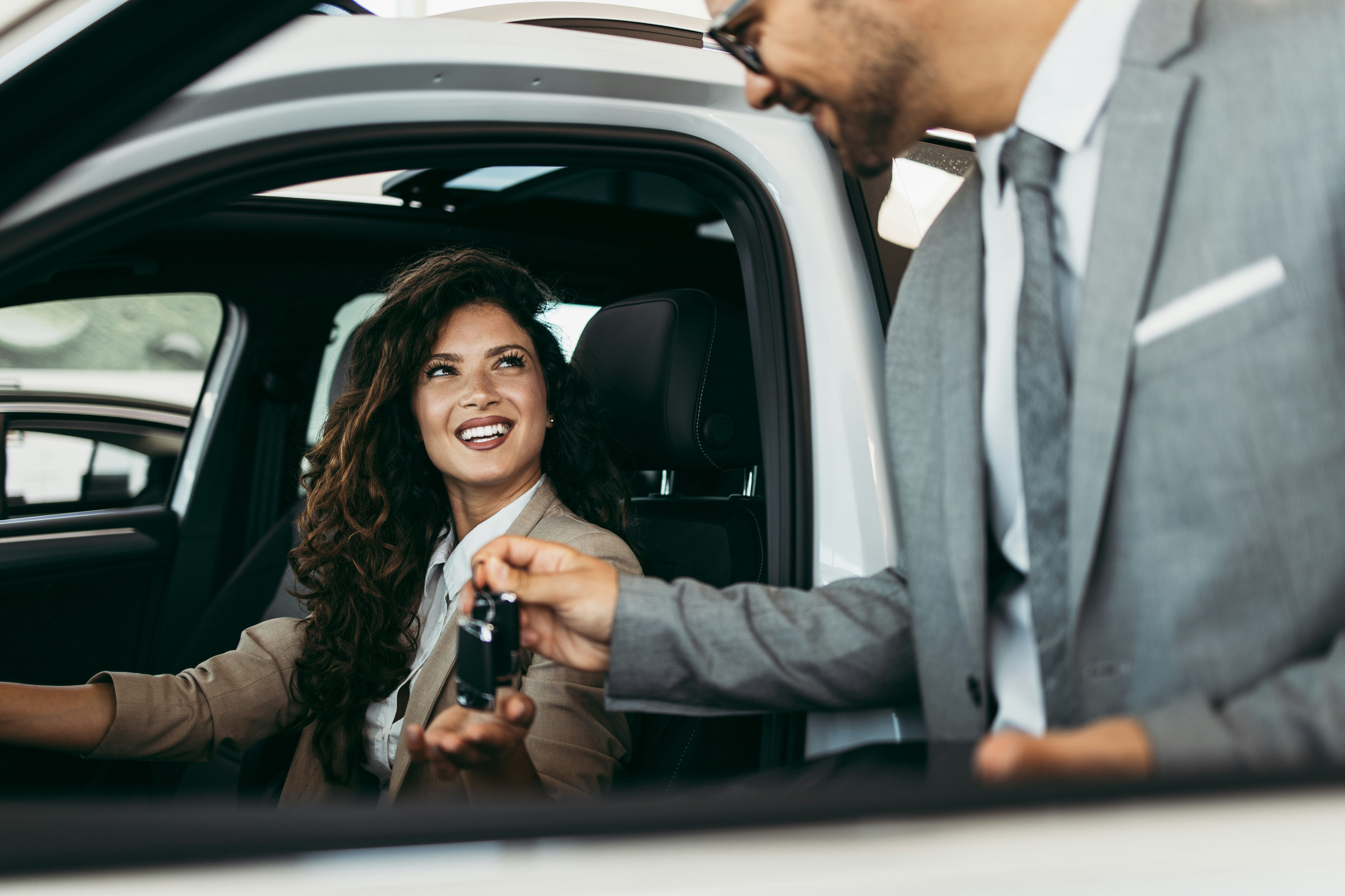 Lady getting car keys from dealership